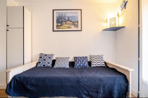 une chambre avec un lit avec des oreillers bleus et blancs dans l'établissement Appartement 