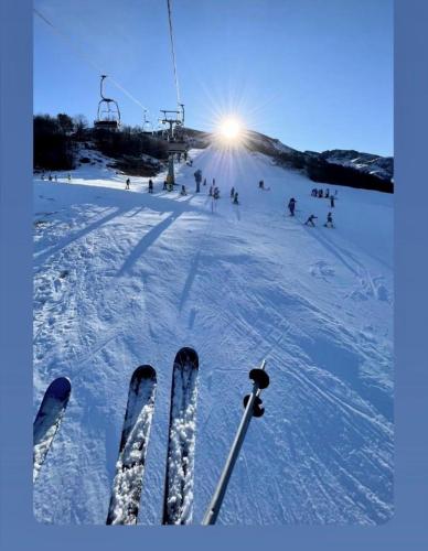 a group of people skiing down a snow covered slope at Casa Olivera in Limone Piemonte