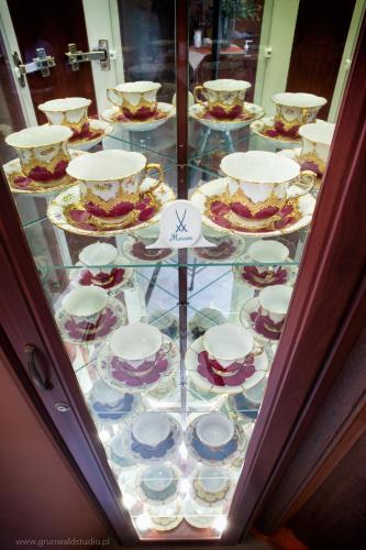 a glass table with plates and dishes on it at HOTEL I RESTAURACJA BROCHÓW in Wrocław