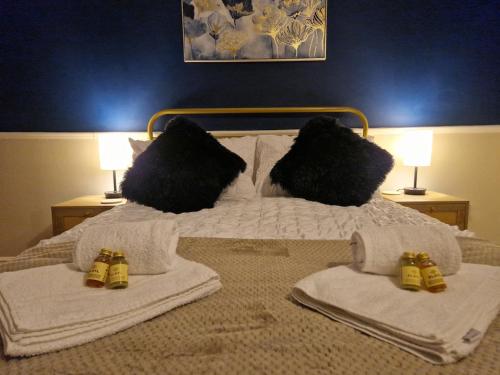 a bed with towels and pillows on it at Markfield Maison in Markfield
