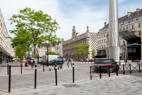 a street in a city with tables and buildings at La Petite Rhonelle - Studio en hypercentre in Valenciennes