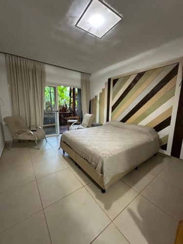 a bedroom with a bed and a chair in it at Cabañas complejo Ysyry Misiones in Puerto Victoria