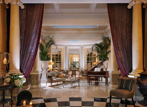 a lobby with a grand piano and a living room at Great Southern Killarney in Killarney
