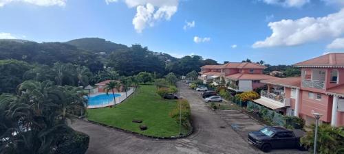 arial view of a street in a residential neighborhood with cars parked at Appartement F2 en résidence avec piscine et plage à 5min à pied in Les Trois-Îlets
