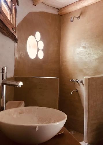 a bathroom with a white sink and a shower at Casa LaMora in San Marcos Sierras