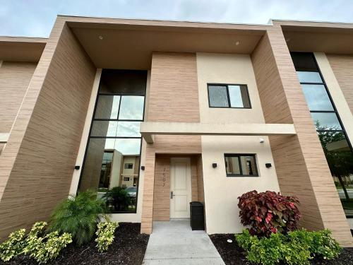 a house with a front door and windows at Luxury Home 7 Min Disney Universal 3BR4BA - Hot Tub in Orlando