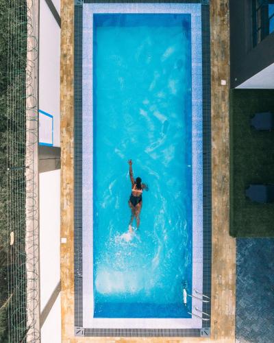 a person in the water in a swimming pool at Skyhut Boutique House Rooftop with LED-LIT DOME & Private Pool - Nairobi in Kitengela 