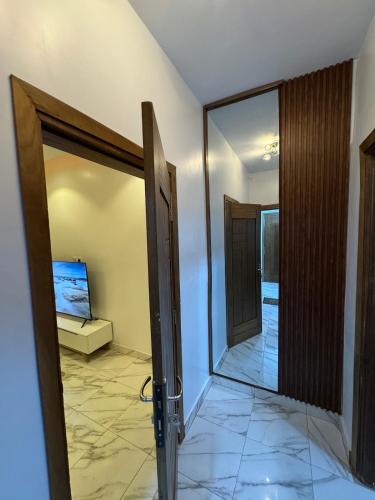 an open glass door in a room with aoyer at logement luxueuse au pieds du monument de la renaissance africaine in Dakar
