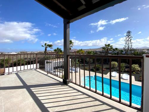 a balcony with a view of a swimming pool at Modern villa in Lajares with private pool in La Oliva