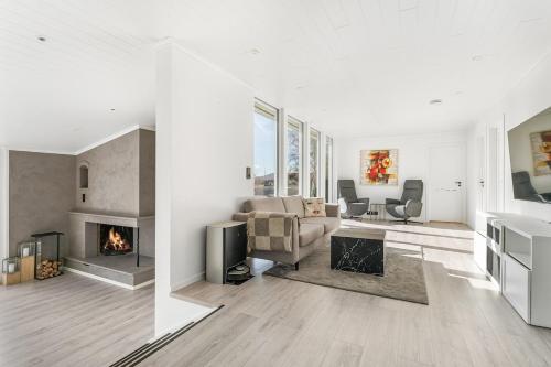 a living room with a couch and a fireplace at Casa Knott 4 Bedroom in Ulstein