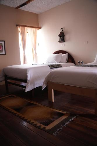 a bedroom with a large bed and a window at Land of the Sun Hotel & Spa in Cotacachi