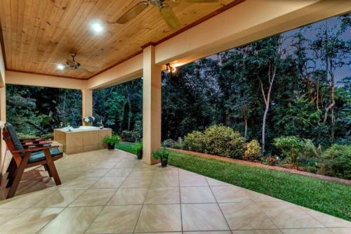 an outdoor patio with a view of a garden at Secluded Romantic Getaway For Two - Kuranda Queensland in Kuranda