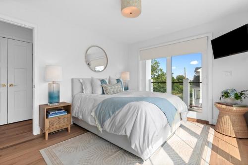 a white bedroom with a bed and a large window at Stareway to Heaven in Fairfield