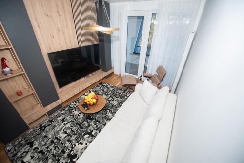 a living room with a white couch and a table at Royal Premium by Vucko Jahorina Serviced Apartments in Jahorina
