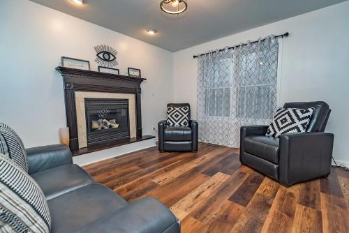 a living room with two chairs and a fireplace at Camelback Ski Mts,Firepit, Hottub,Kalahari WaterPark,Linens! in Cresco