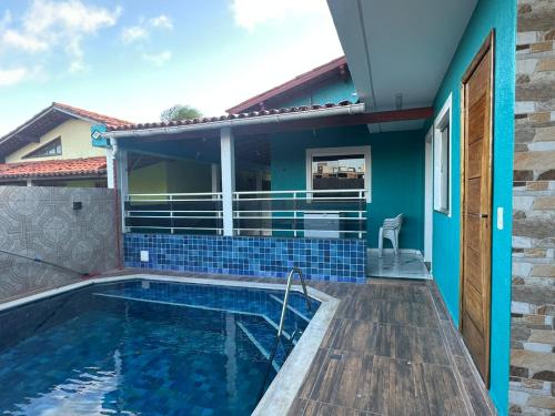 a swimming pool in a house with blue tiles at Lessa imob in Salinópolis