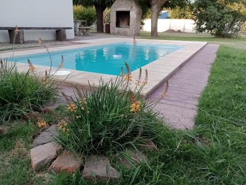 a swimming pool with a walkway next to a yard at Santa Teresa, hospedaje rural in Antonio Carboni