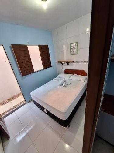 a bedroom with a large bed in a room at Pousada São João in Jericoacoara