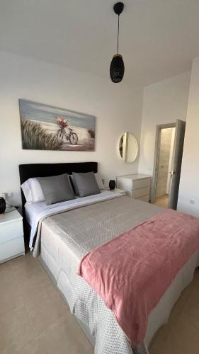 a bedroom with a bed with a bike on the wall at Casa Yanelis in Antigua