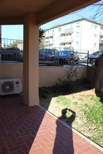 a shadow of a person on a patio with a building at NOAcH experience in Livorno