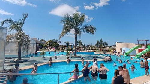a group of people in a swimming pool at a resort at Cabañas MYM en Termas de Basavilbaso in Basavilbaso