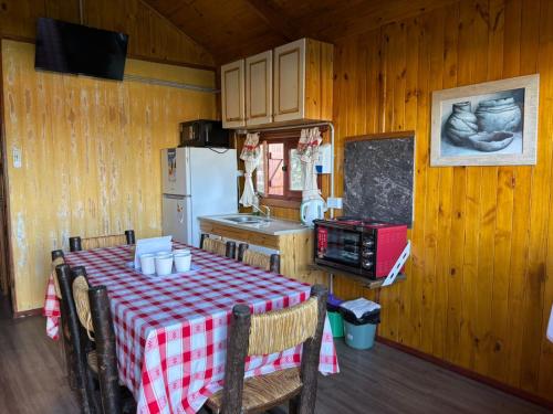 a kitchen with a table with a red and white checkered table cloth at Las Torres del Sol in Villa Lía