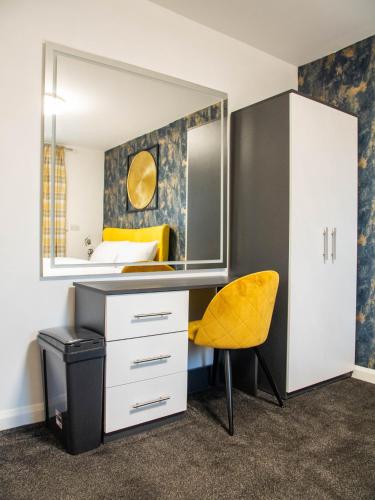 a bedroom with a desk and a yellow chair at Norfolk Heritage Park Rooms - Sheffield in Victoria