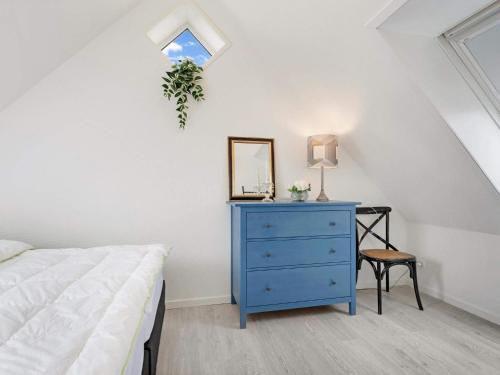 a bedroom with a blue dresser and a mirror at Cozy Retreat in Lokken - By Traum Ferienwohnungen in Løkken