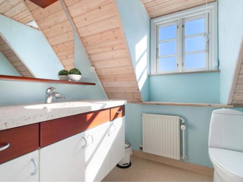 a bathroom with a sink and a window at Cozy Coastal Retreat - By Traum Ferienwohnungen in Løkken