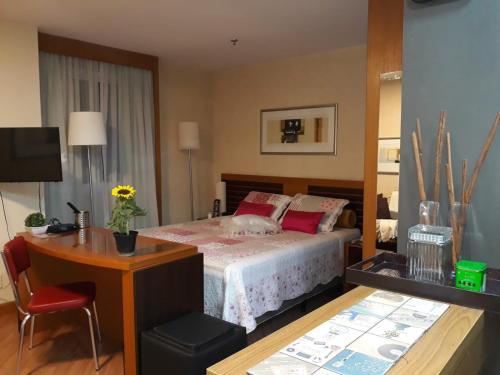 a bedroom with a bed and a table and a desk at Wyndham São Paulo Paulista in Sao Paulo