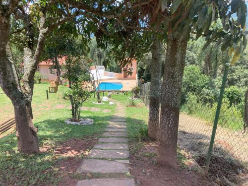 a stone path between two trees in a park at Refúgio Vista da Mata in Mairiporã
