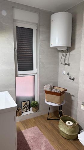 a small bathroom with a sink and a window at Divčibarski pogledi in Divčibare
