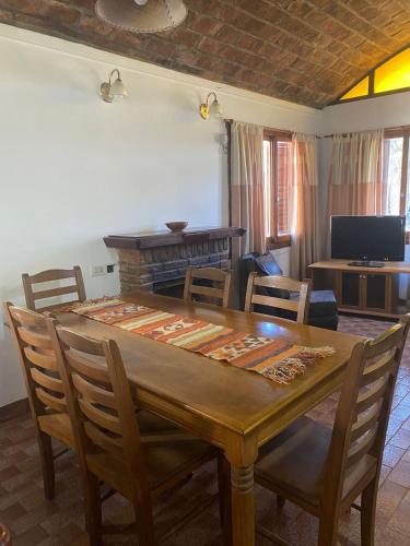 a living room with a wooden table and chairs at Duplex la 70 in San Clemente del Tuyú