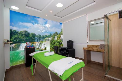 a room with a wall mural of a waterfall at Hotel deluxe oasis de la colina boutique in Girardot