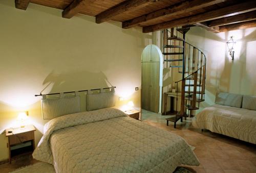 En eller flere senge i et værelse på Tenuta Merlano