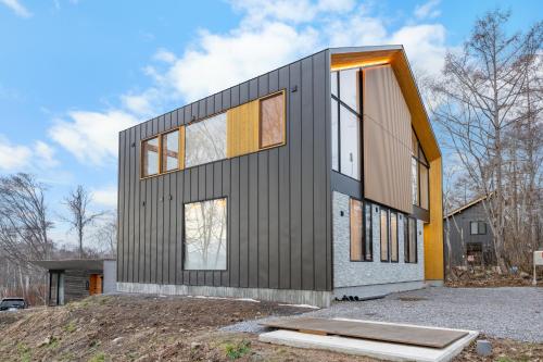 a house being built on top of a hill at AOYAMA VILLA in Kombu