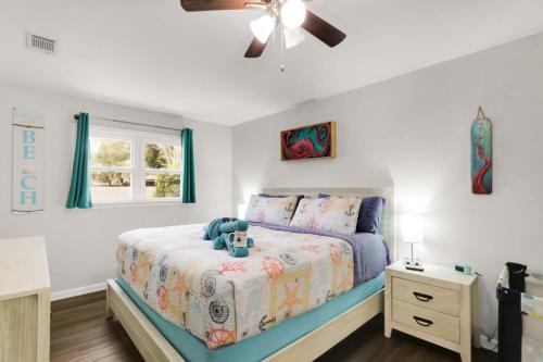a bedroom with a bed with a teddy bear on it at Ocean - 5 Beds Retreat with Pickleball, Arcade, Grill & Beach Access! in Fort Walton Beach