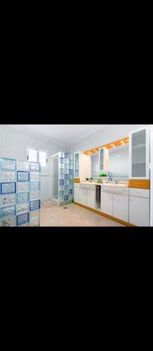 a large kitchen with white cabinets and blue appliances at Torrebeach in Torre de la Horadada