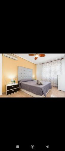 a bedroom with a large bed and a window at Torrebeach in Torre de la Horadada