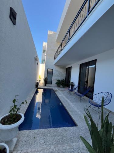 a swimming pool in front of a house at Casa Privada Acapulco in Acapulco