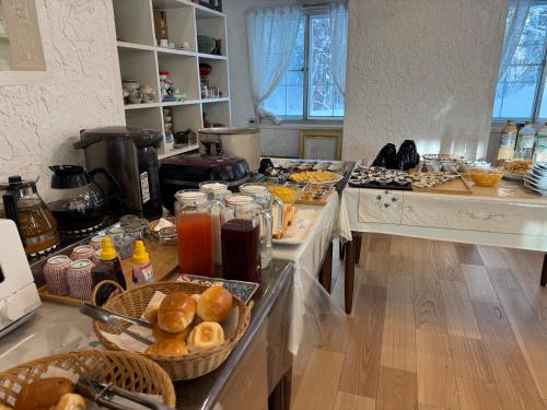 a kitchen with a counter with food on it at TERUKA白いテラスHakuba in Hakuba