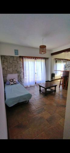 a bedroom with a bed and a wooden table at Alfonsina y el Mar in Mar del Plata