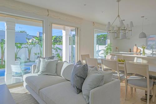 a living room with a couch and a dining room at Seaside Cottage Sumuide in Nago