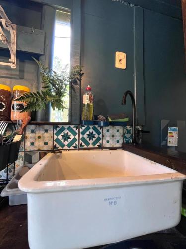 a bath tub in a bathroom with a sink at Cabaña Luna Rubia in La Pedrera