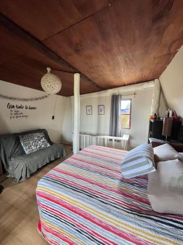 a bedroom with a large bed in a room at Cabaña Luna Rubia in La Pedrera