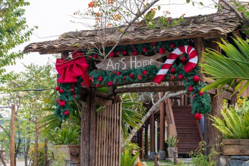 an art house with a christmasreath and a sign at Anans Home Ha Giang - Tours & Motorbike Rental in Ha Giang