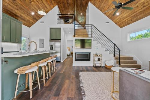 a kitchen and living room with a spiral staircase at The June Hot tub with king beds on 2 acres in Hot Springs