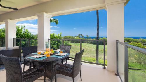 a dining room with a table and chairs on a balcony at ❤PiH❤ Mauna Kea SunsetsOcean and Golf ViewsOptional Mauna Kea Hotel Privileges in Hapuna Beach