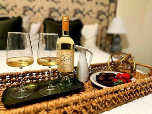 a tray with two glasses of wine and a plate of food at Walk to GWCC, Mercedes-Benz in Atlanta