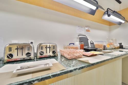 a kitchen with two toasters on a counter at Brown Dot Hotel Ulsan Samsan in Ulsan